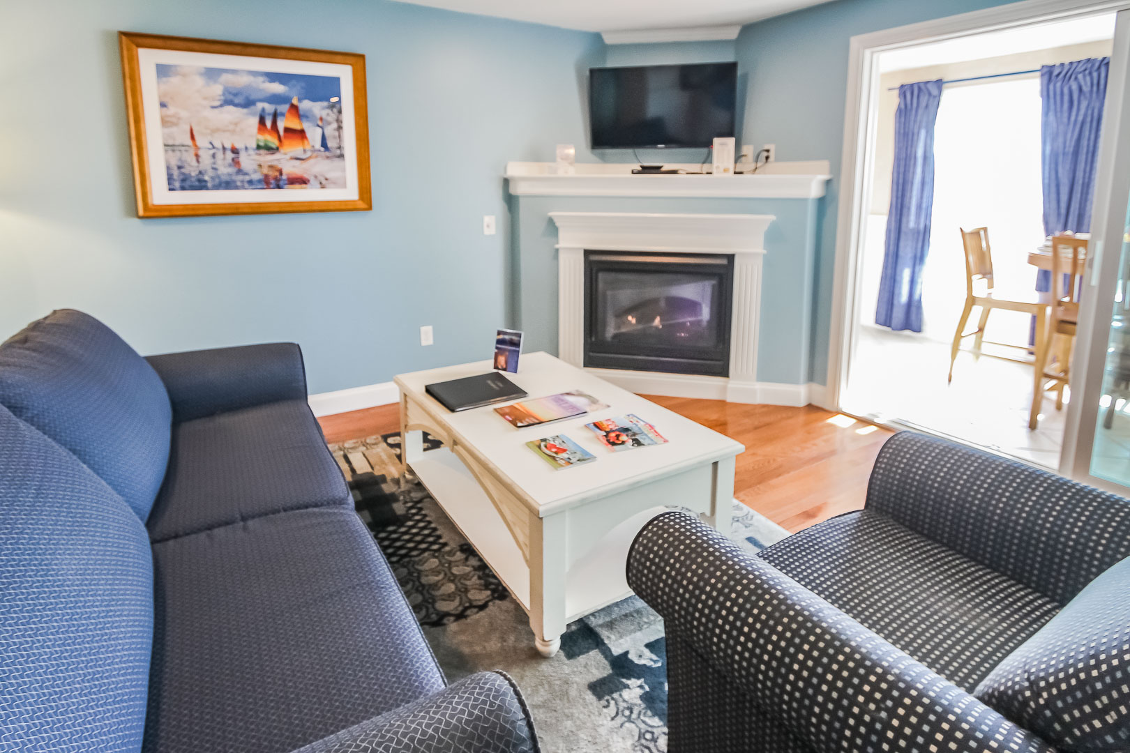 A refreshing living room area with a kitchenette at VRI's Edgewater Beach Resort in Massachusetts.